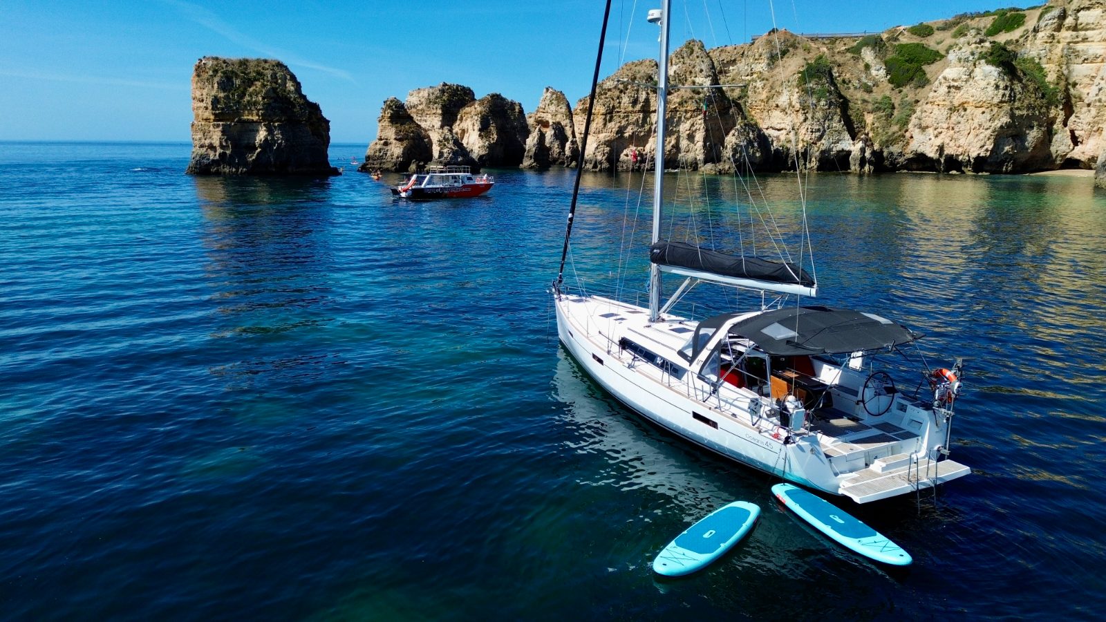 Full-day charter anchored in a quiet cove on the Algarve coast